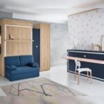 Shared youth bedroom with two folding beds; one with a folding desk and the other with a sofa