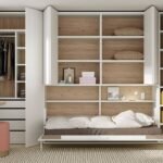 U+D series horizontal folding bed inserted in an asymmetric bookcase with extendable table